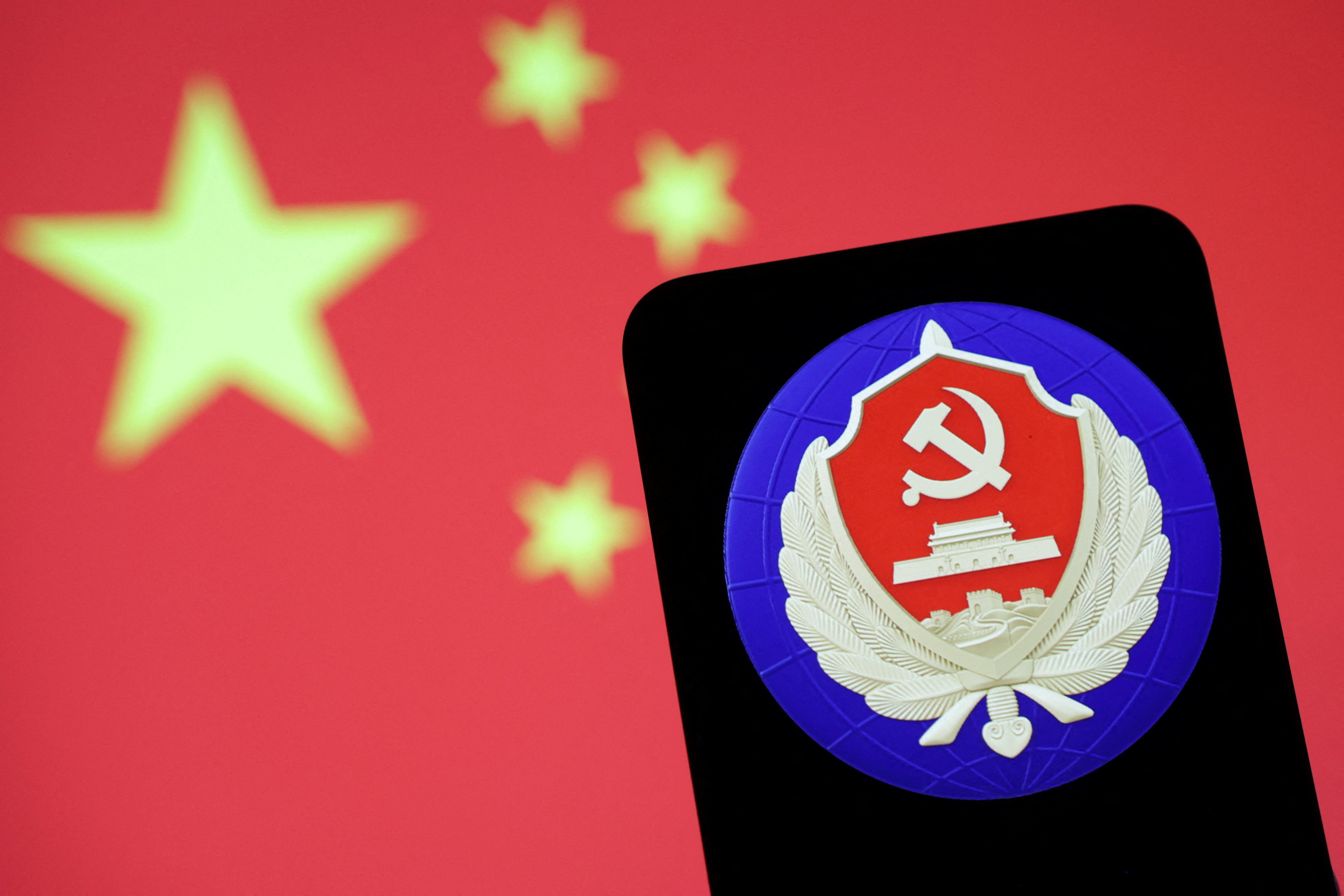 Illustration shows MSS (Ministry of State Security) logo and Chinese flag
