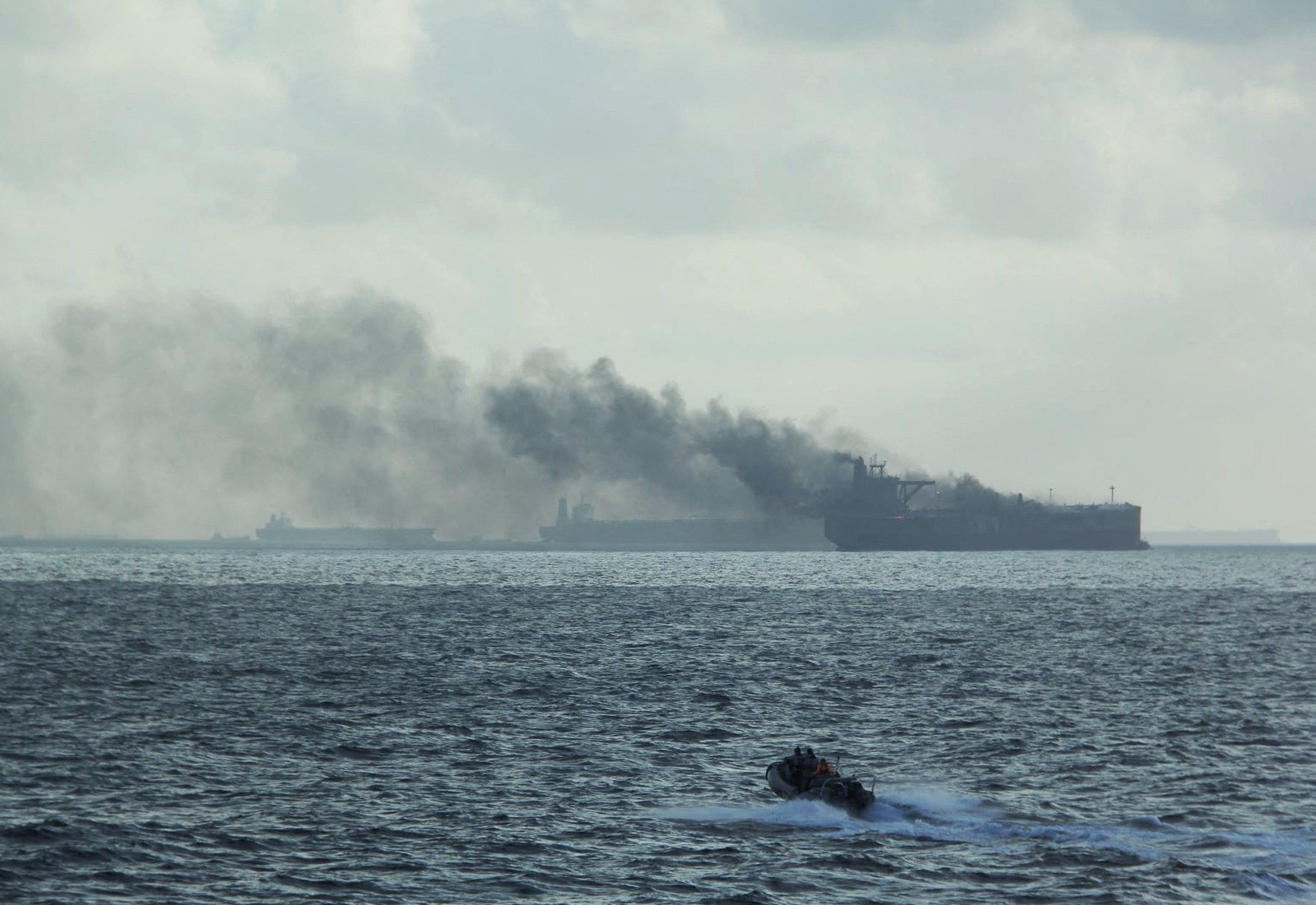 FILE PHOTO: Rescue teams reach oil tankers on fire off the Singaporean island of Pedra Branca