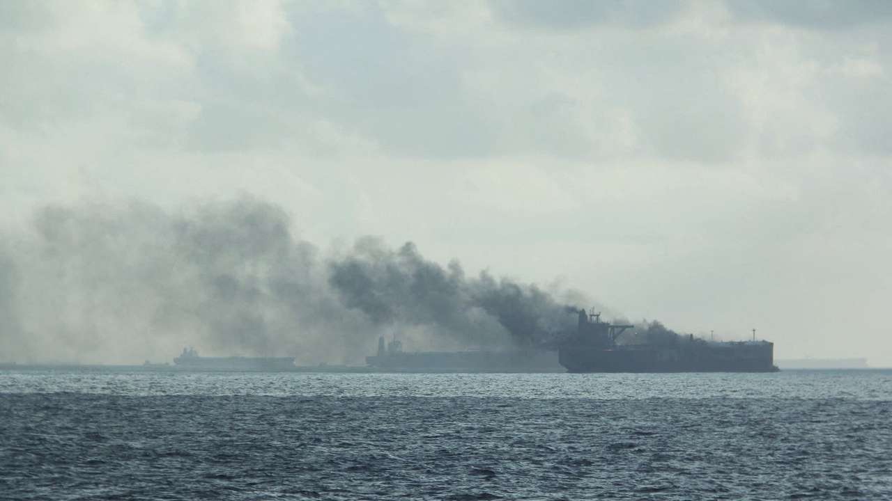 FILE PHOTO: Rescue teams reach oil tankers on fire off the Singaporean island of Pedra Branca