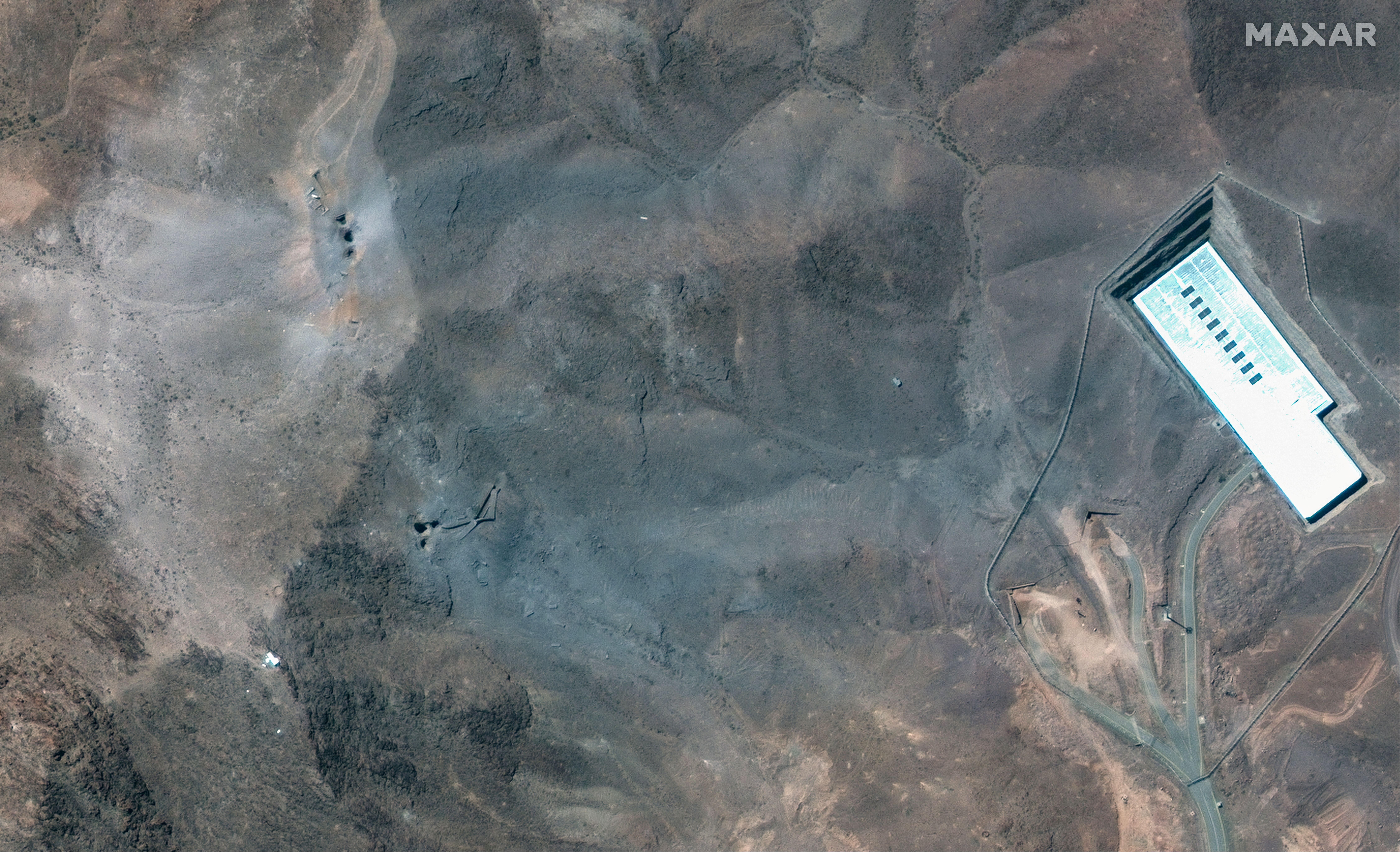 A closer satellite view shows the ridge at Fordow underground complex, after the U.S. struck the underground nuclear facility, near Qom