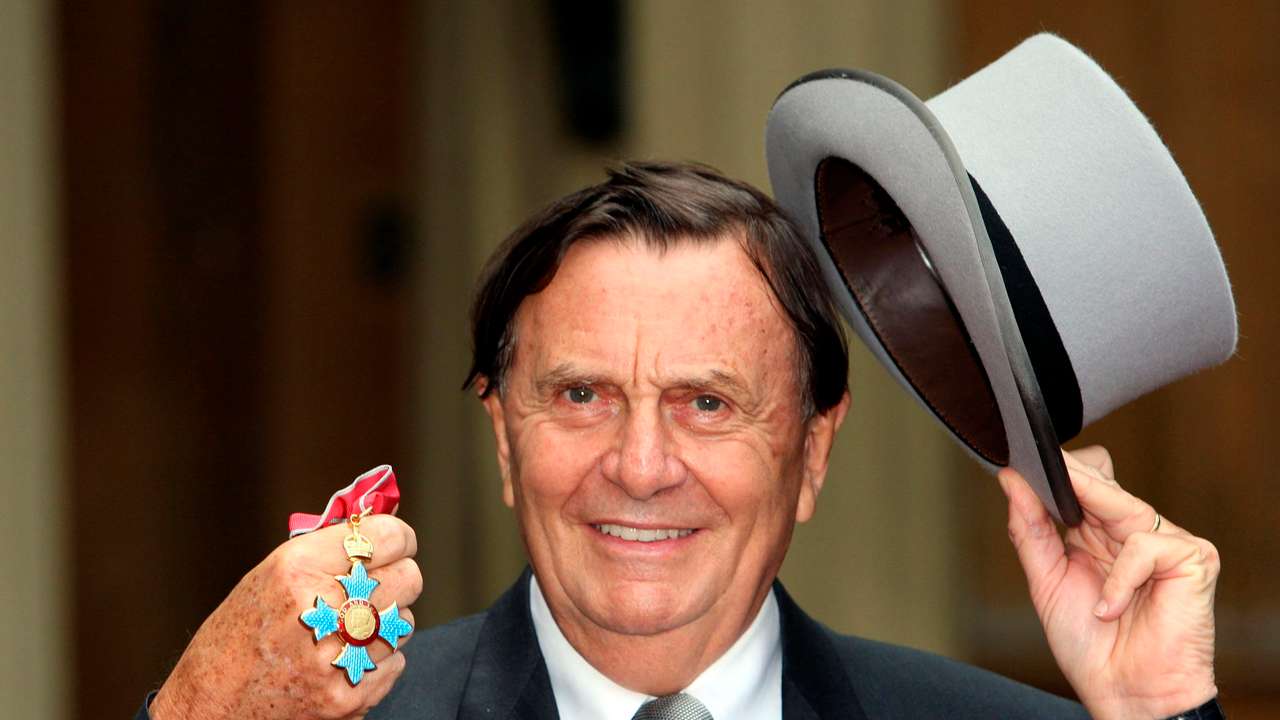 Australia's Barry Humphries poses after receiving his Most Excellent Order of the British Empire from the Queen at Buckingham Palace, London
