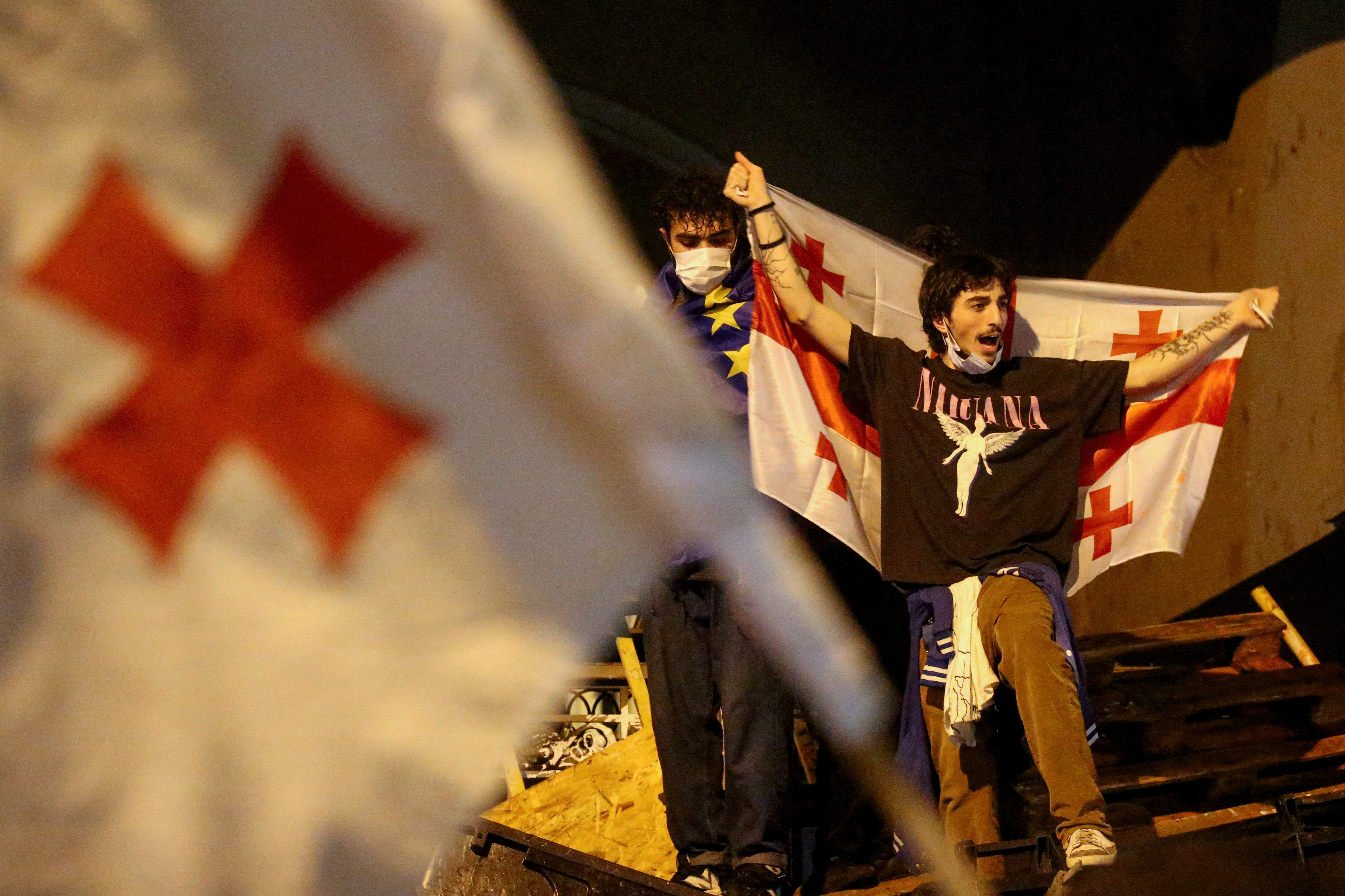FILE PHOTO: Demonstrators hold a rally to protest against a bill on "foreign agents", in Tbilisi