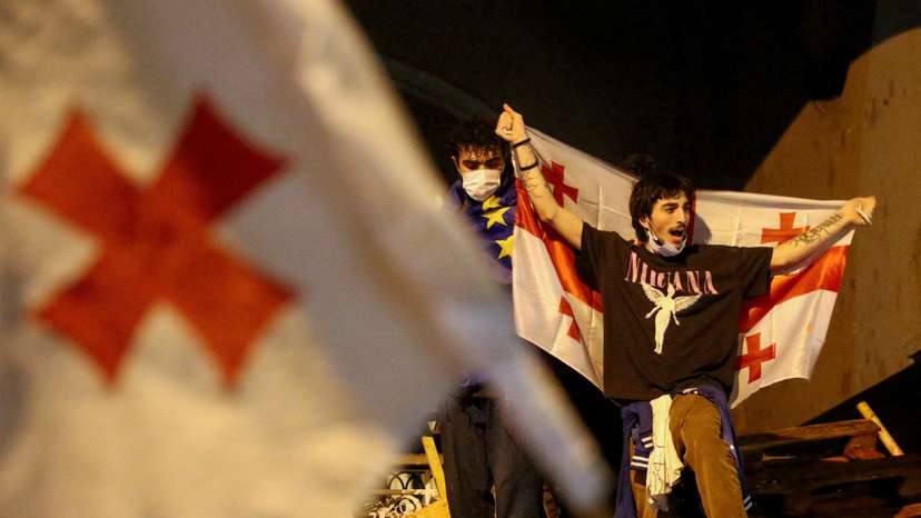 FILE PHOTO: Demonstrators hold a rally to protest against a bill on "foreign agents", in Tbilisi