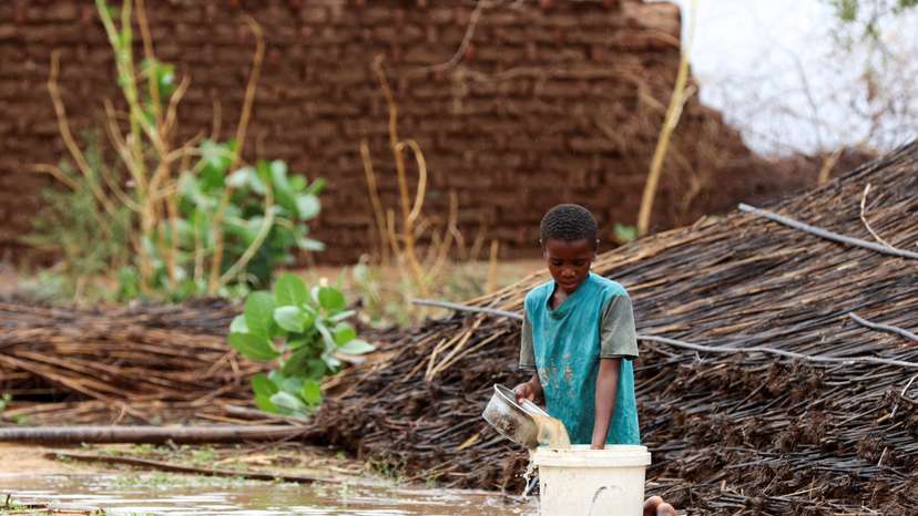 FILE PHOTO: Displaced Sudanese child pours water at Zamzam camp in North Darfur