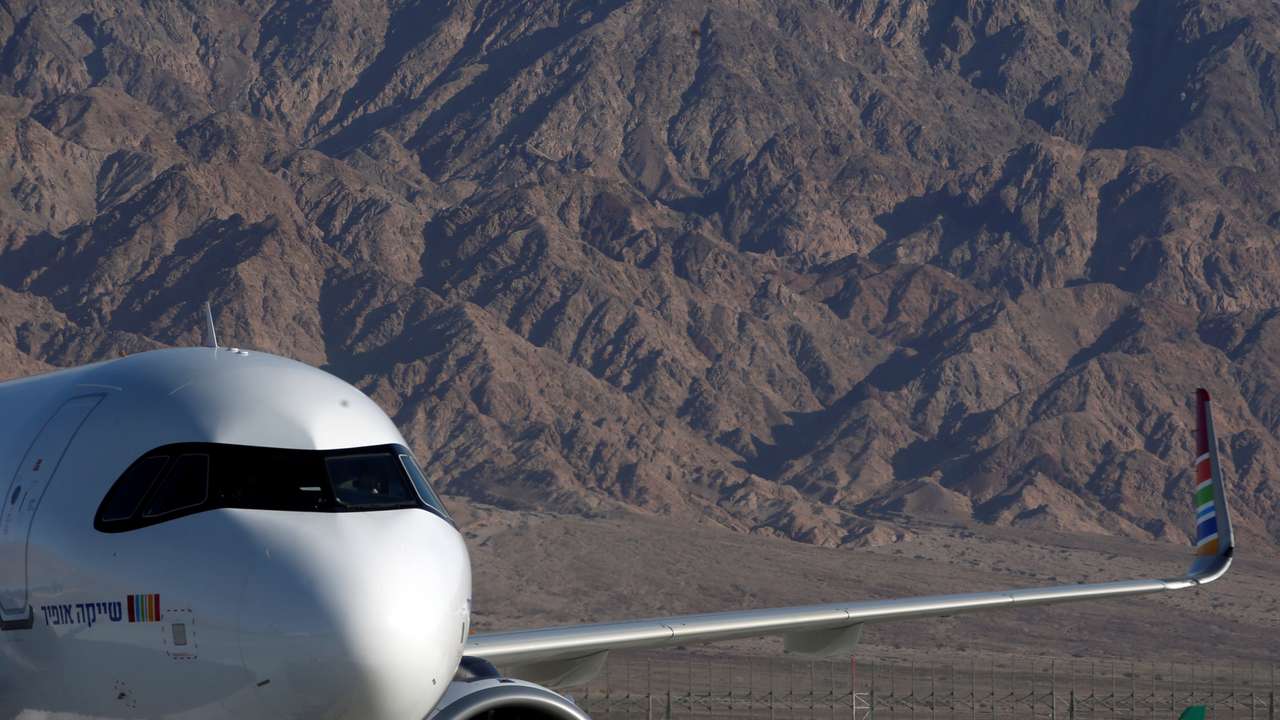 FILE PHOTO: An Arkia Israeli Airlines Embraer plane is seen in the background at Ramon International Airport