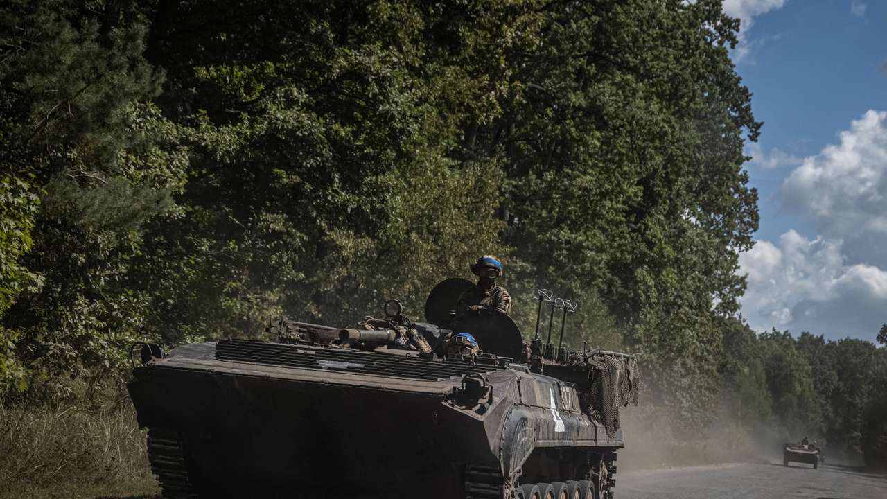Ukrainian service members ride a BMP-1 infantry fighting vehicle near the Russian border in Sumy region
