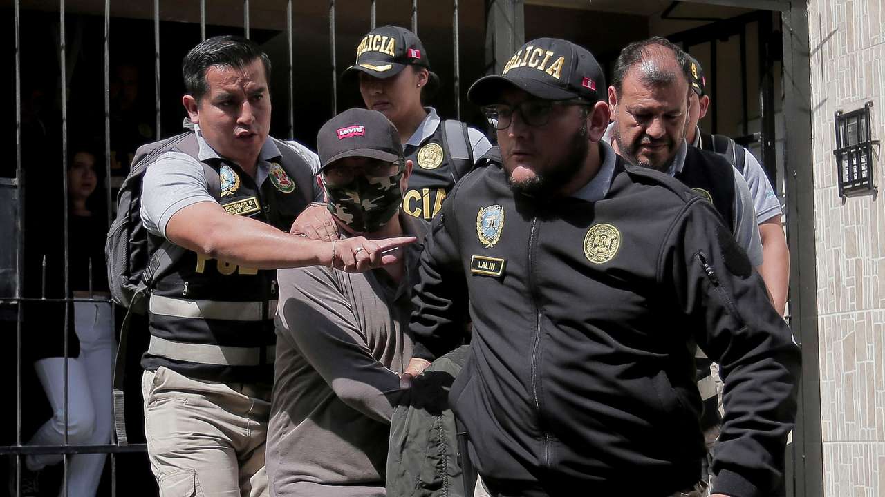 Police officers escort Nicanor Boluarte, brother of Peruvian President Dina Boluarte, in Lima