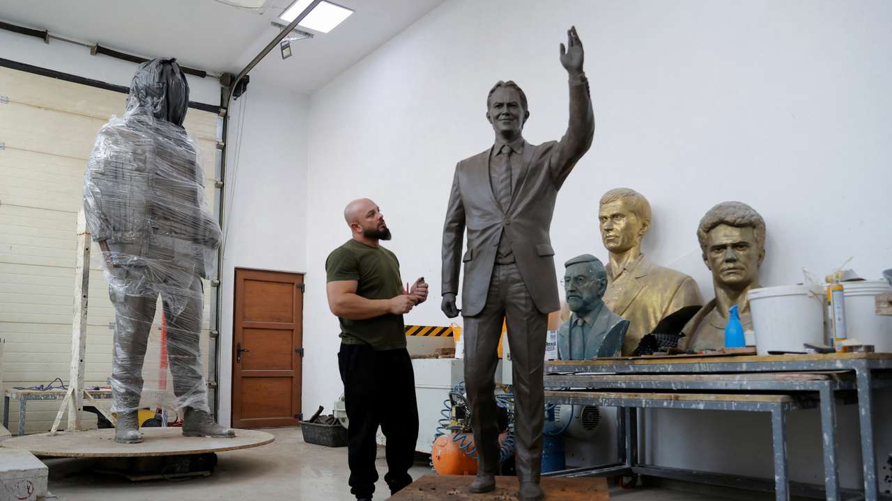 Sculptor Agon Qosa works on a statue of Britain's former prime minister Tony Blair, in Ferizaj