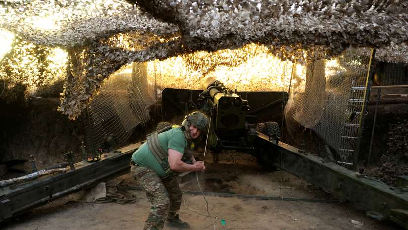 Ukrainian service members fire a 2A36 Giatsint-B howitzer towards Russian troops, at a position on a front line near the town of Kupiansk, in Kharkiv region