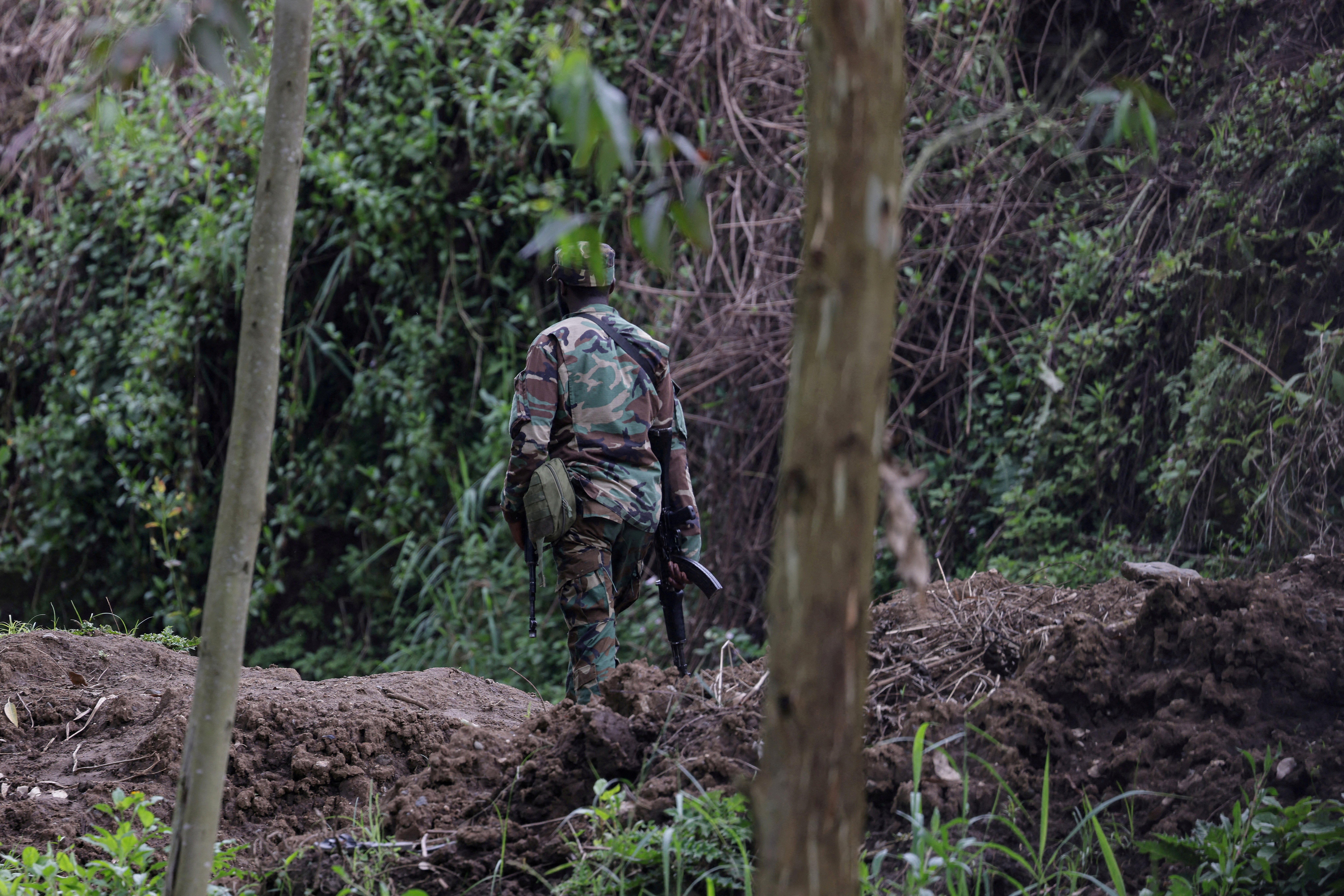 FILE PHOTO: An M23 rebel walks on the outskirts of Matanda