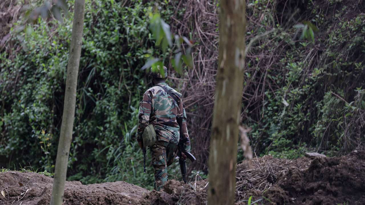 FILE PHOTO: An M23 rebel walks on the outskirts of Matanda