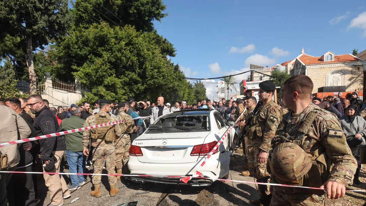 Members of the Lebanese army gather near a damaged vehicle in Jadra