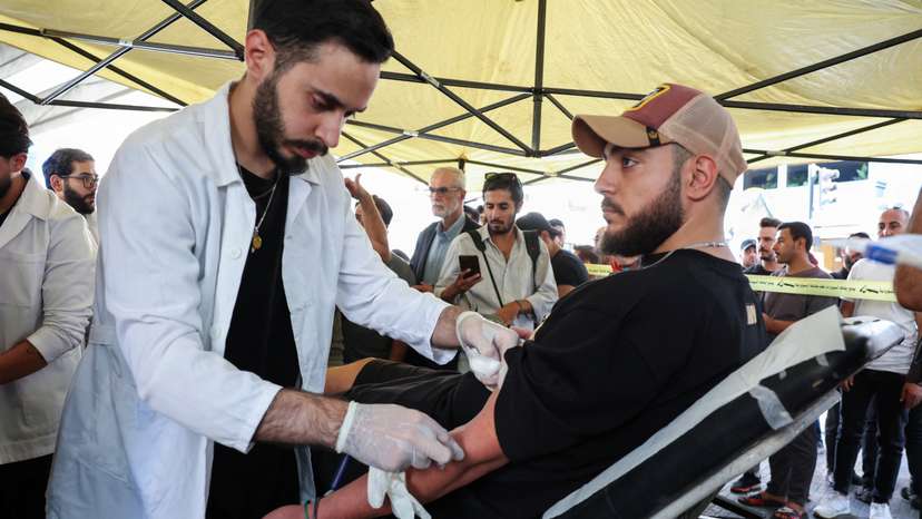 A man donates blood, following pager detonations across Lebanon on Tuesday, in Beirut suburbs