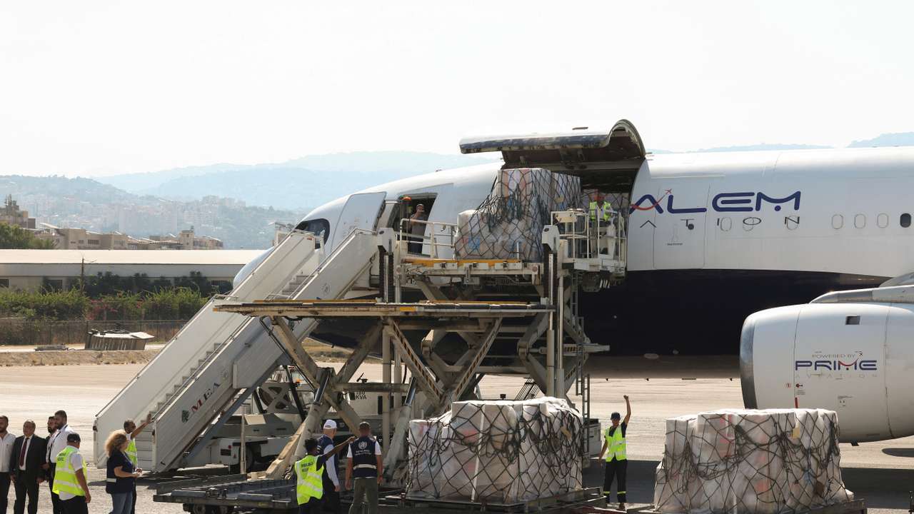 Workers unload medical supplies delivered by the World Health Organization for any potential health crisis resulting from hostilities, in Beirut
