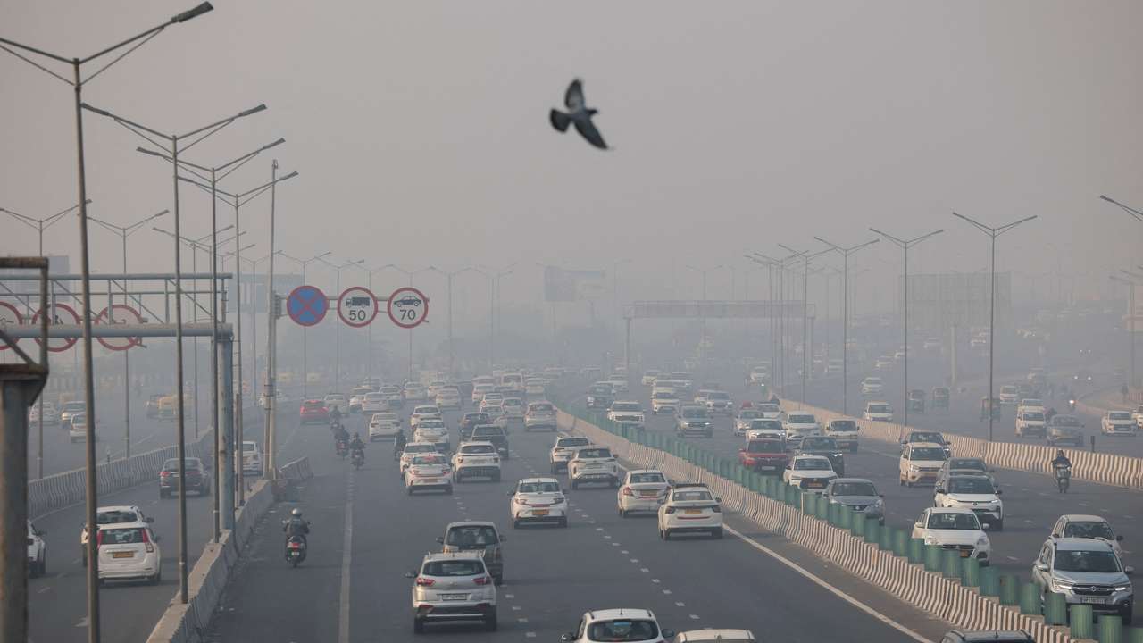 Vehicles ply on a highway, on a smoggy morning amid ongoing air pollution, in New Delhi