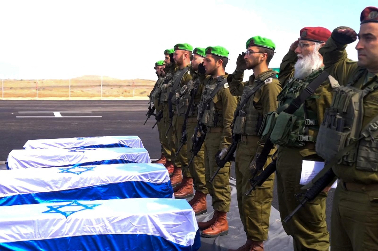 Israeli soldiers recieve the coffines of deceased hostages in Gaza