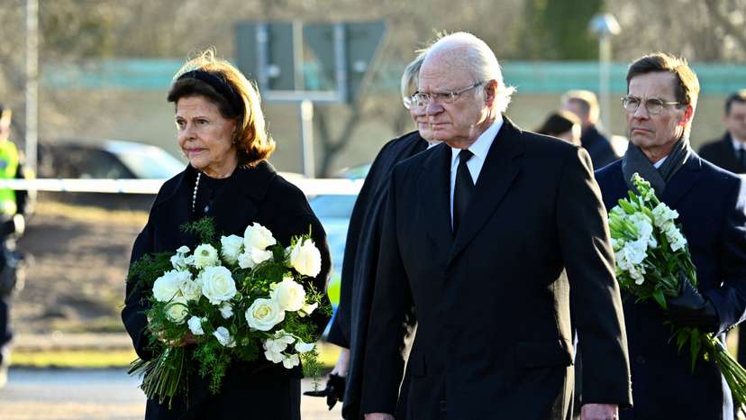 Sweden's King Carl Gustaf and Queen Silvia visit the memorial site where mourners placed candles and flowers outside Campus Risbergska School in Orebro