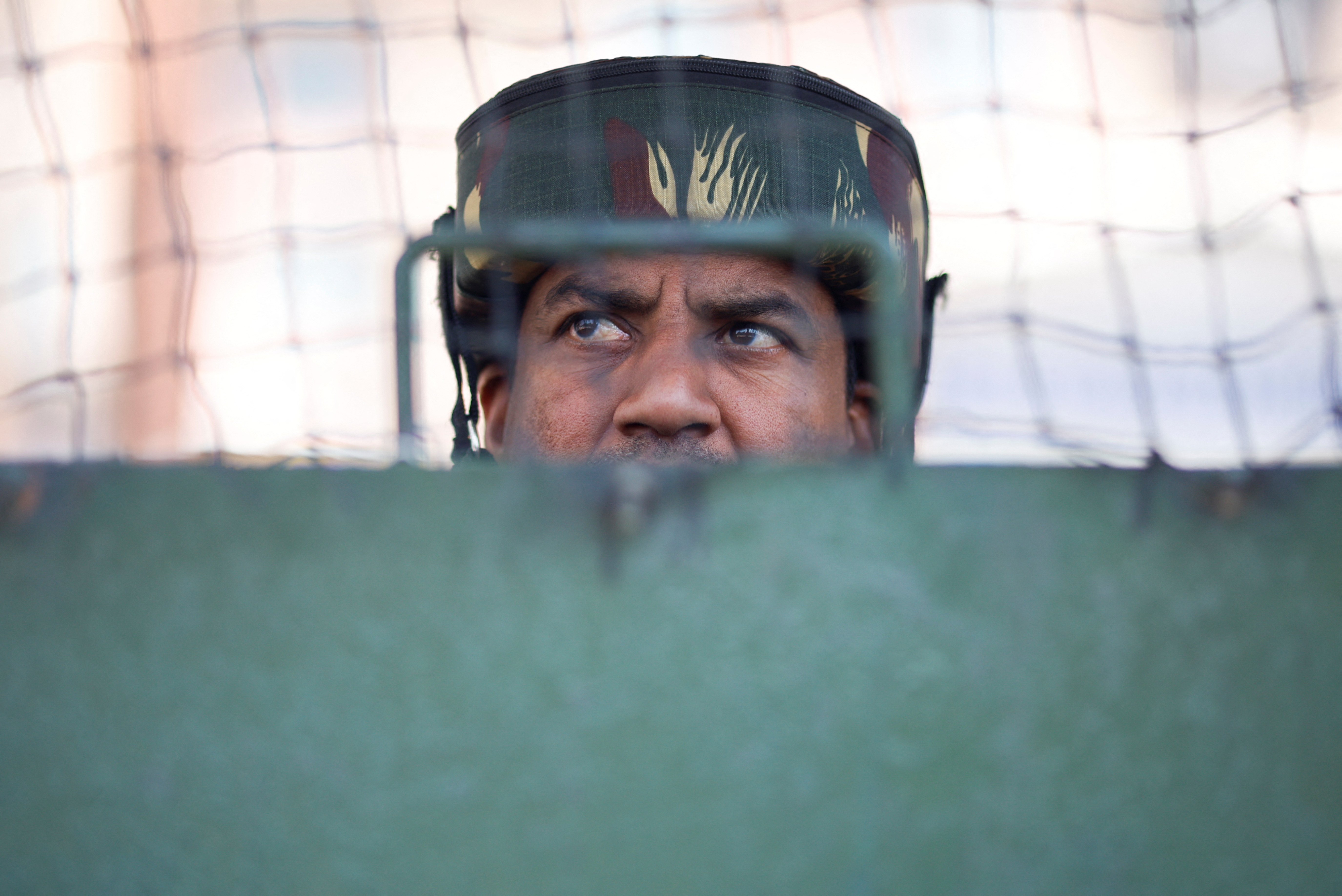 An Indian security force personnel stands guard on a street, following a suspected militant attack near south Kashmir's Pahalgam