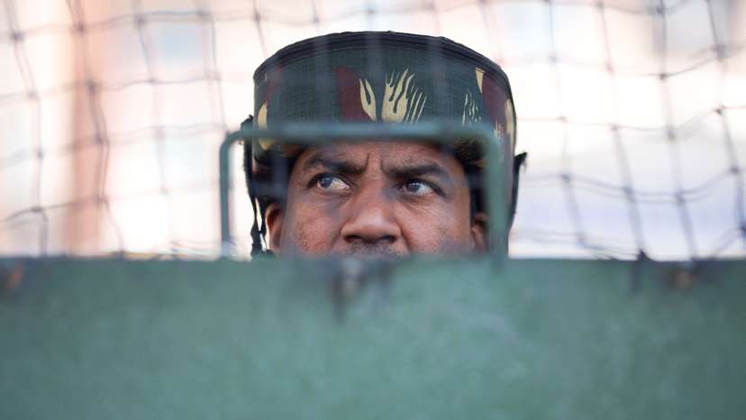 An Indian security force personnel stands guard on a street, following a suspected militant attack near south Kashmir's Pahalgam