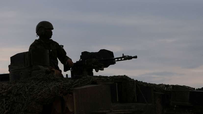 FILE PHOTO: A recruit of the Swiss army Tank School 21 performs an attack exercise with the Leopard 2 tank in Bure
