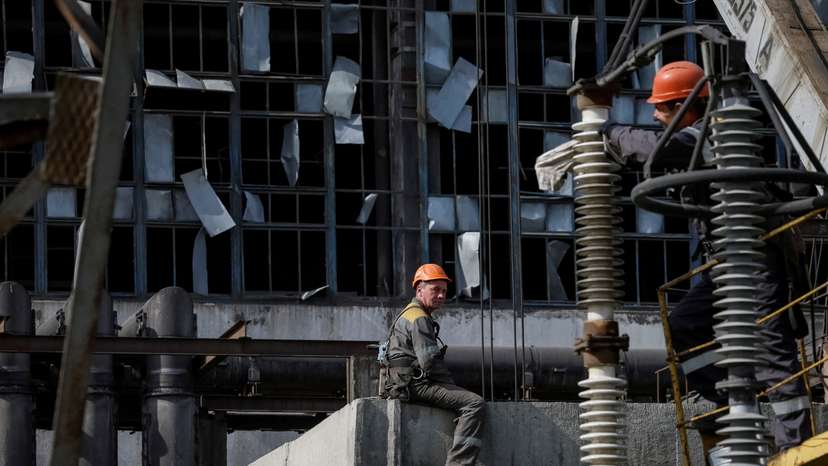 FILE PHOTO: People work at a thermal power plant damaged by recent Russian missile strike