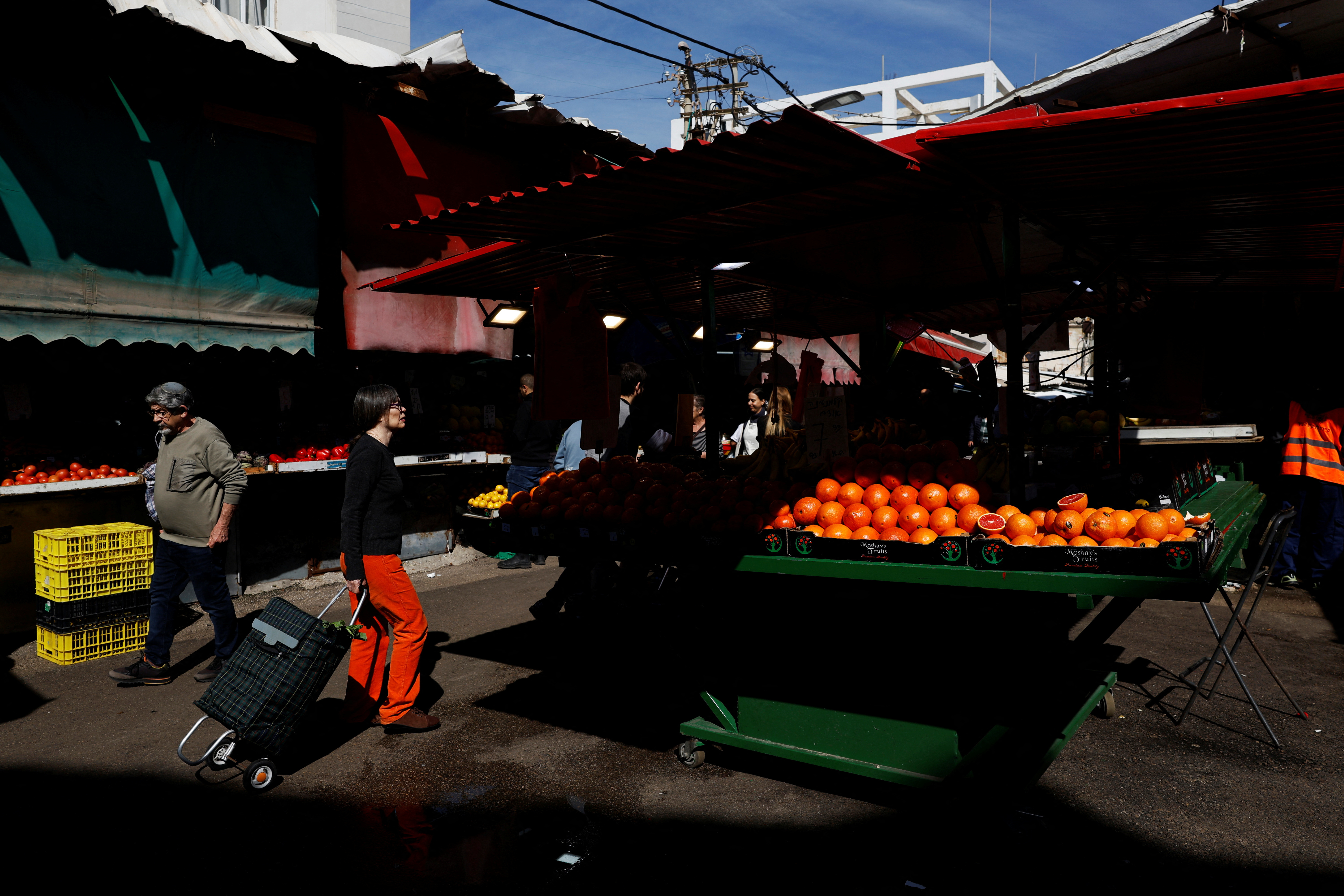 People shop at Carmel Market (Shuk Hacarmel) amid the ongoing conflict between Israel and Hamas, in Tel Aviv