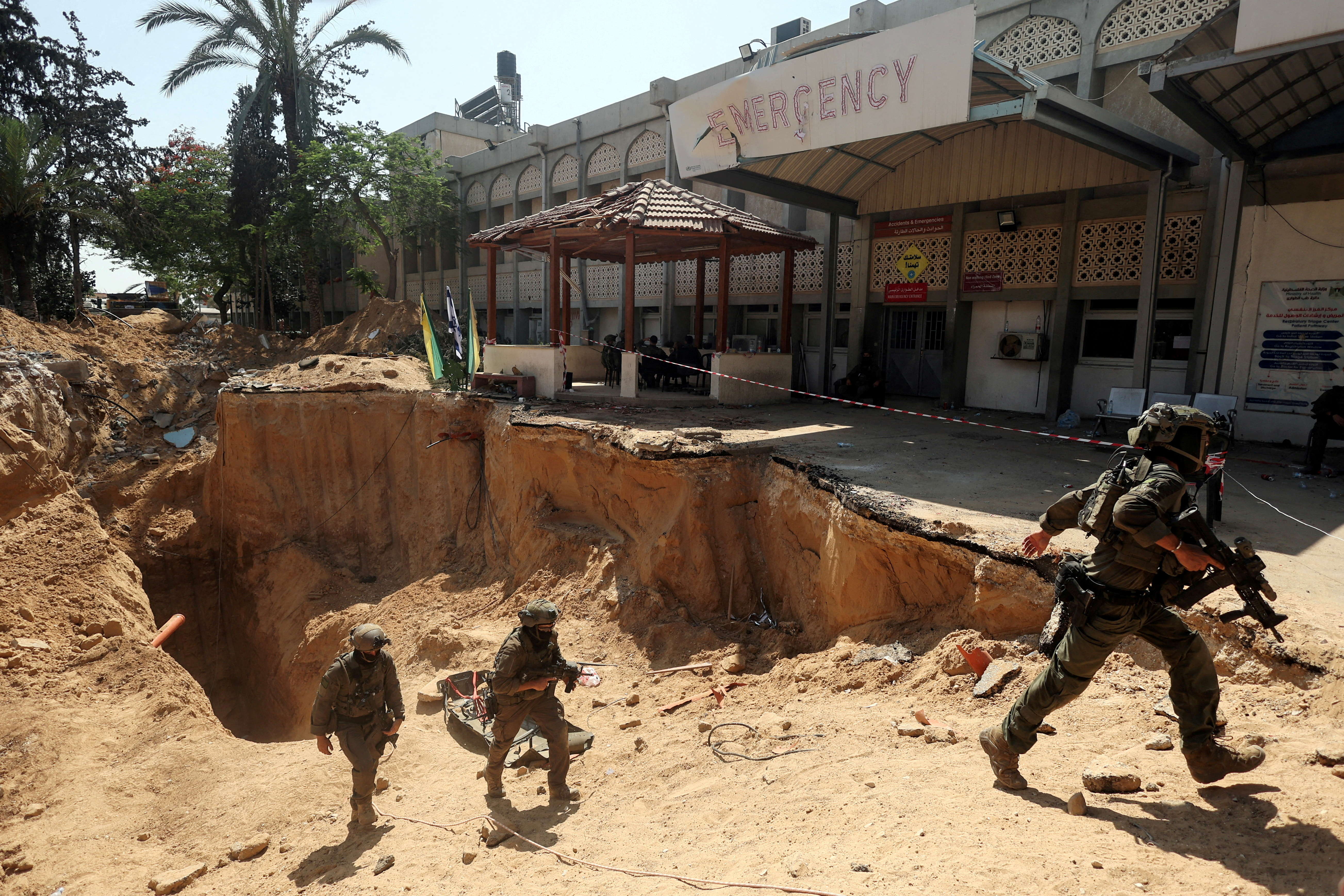FILE PHOTO: Israeli soldiers walk out from a tunnel underneath the European Hospital in Khan Younis at the Gaza Strip