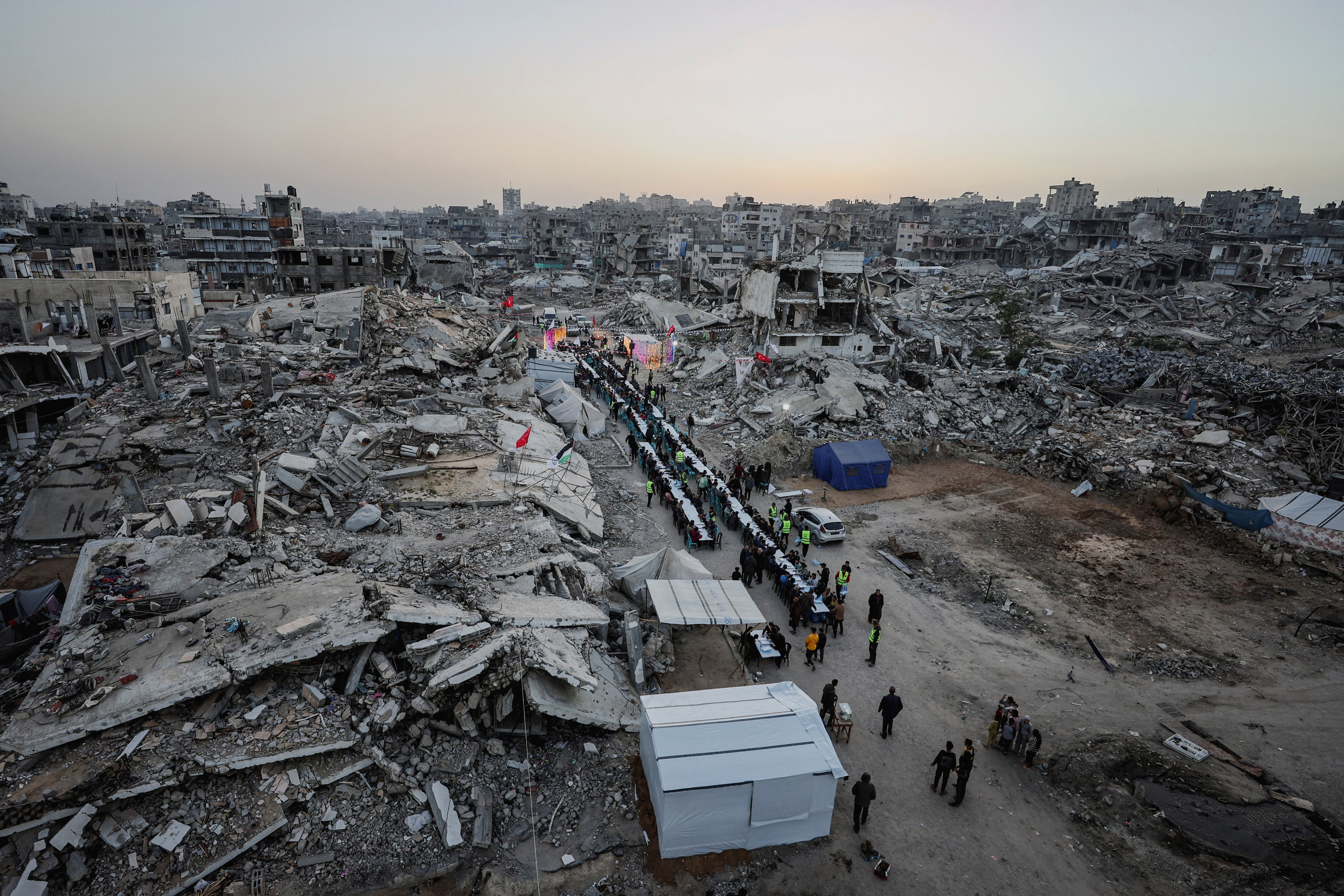 Palestinians gather to break their fast by eating Iftar meals on the first day of the holy month of Ramadan, in Gaza City