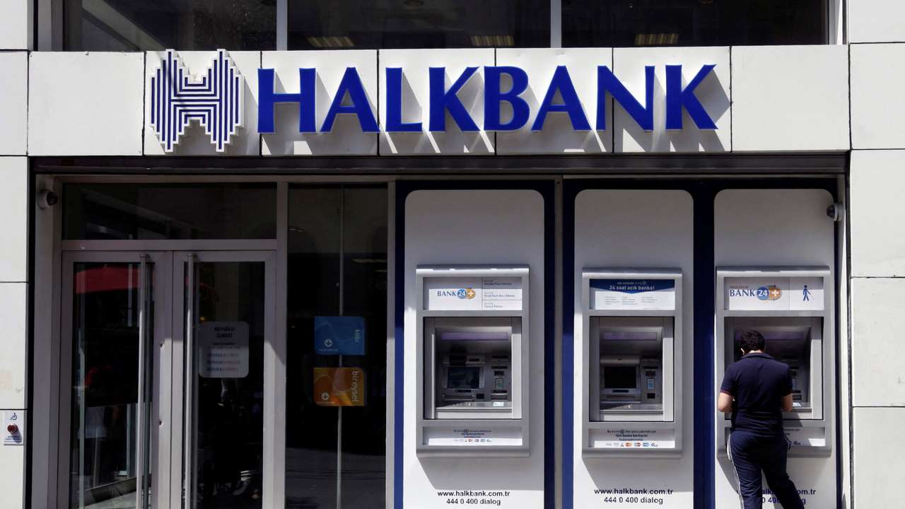 FILE PHOTO: A customer uses an automated teller machine at a branch of Halkbank in Istanbul