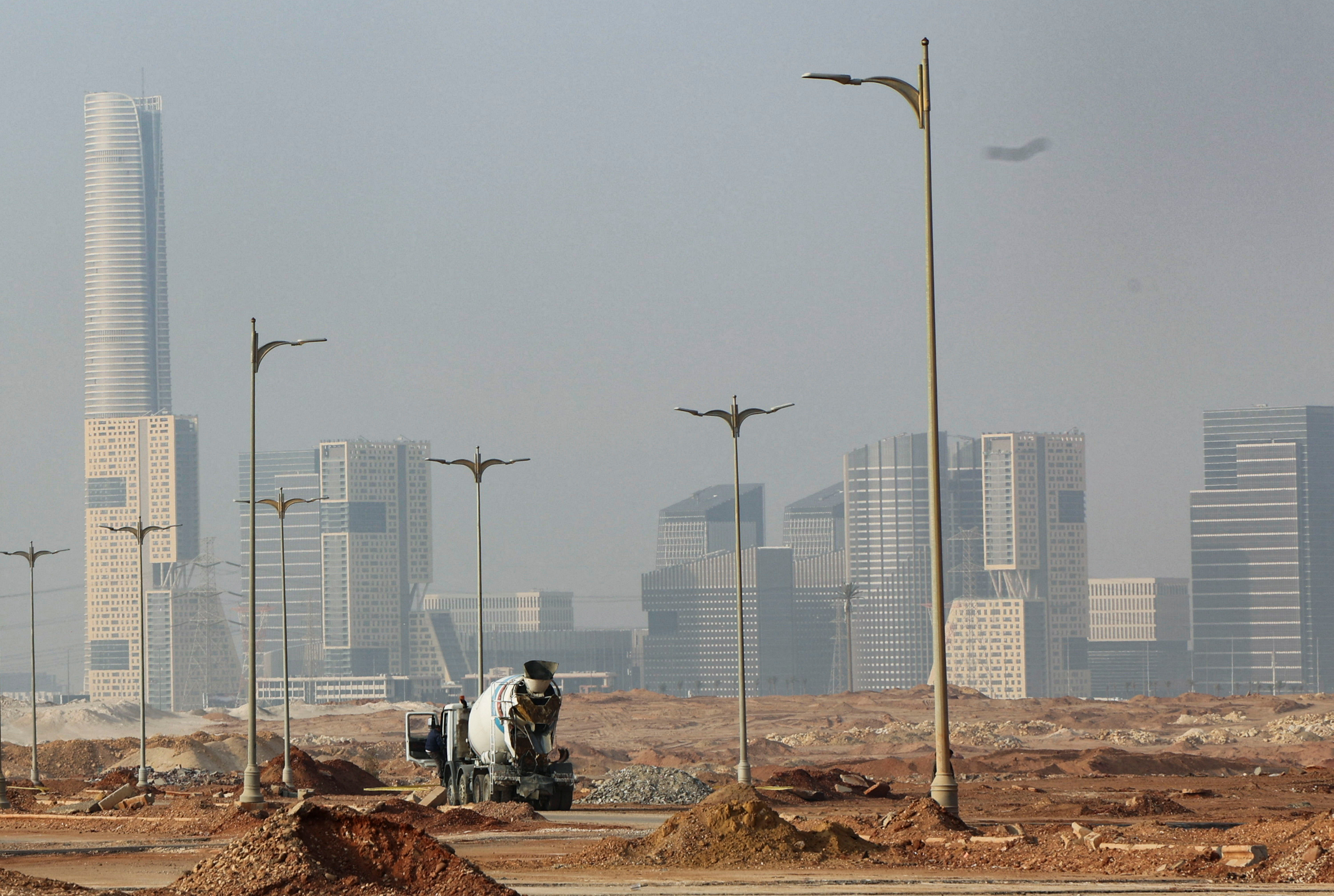 An Egyptian worker drives a construction tractor on the road at the New Administrative Capital (NAC) in the desert east of Cairo