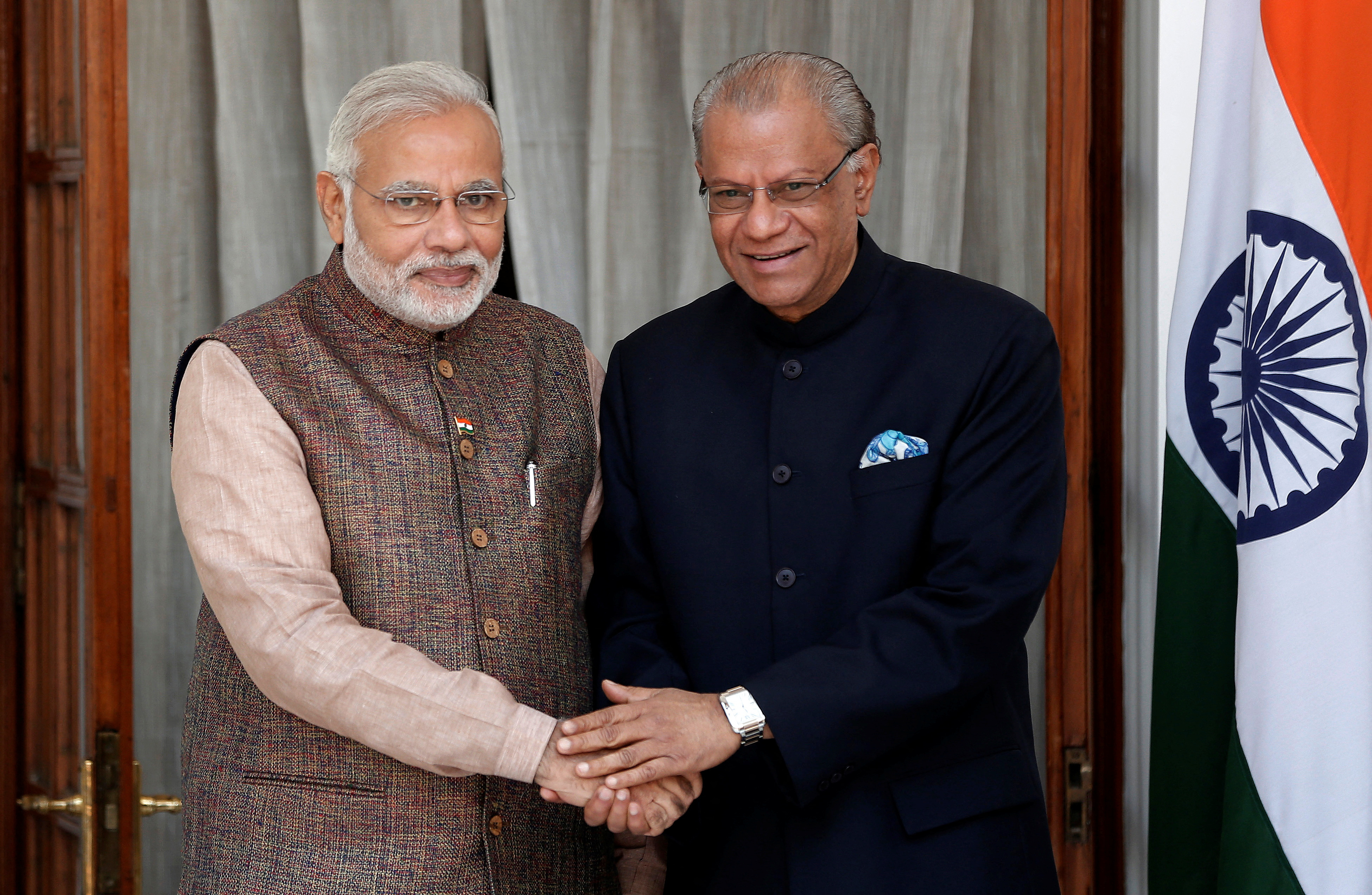 FILE PHOTO: India's PM Modi shakes hands with his Mauritian counterpart Ramgoolam before the start of their bilateral meeting in New Delhi