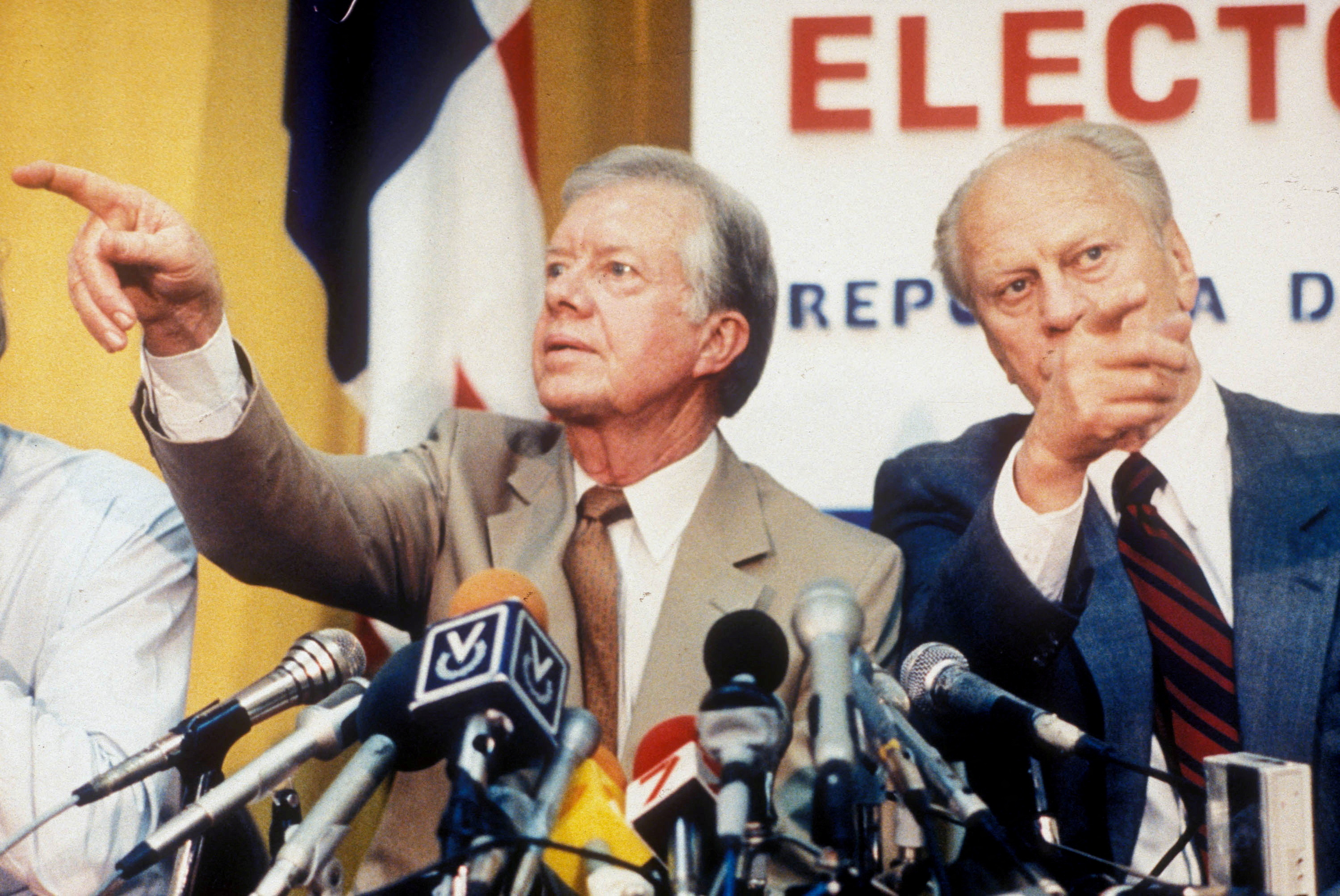 FILE PHOTO: Former U.S. Presidents Carter and Ford point in different directions at a press conference in Panama City