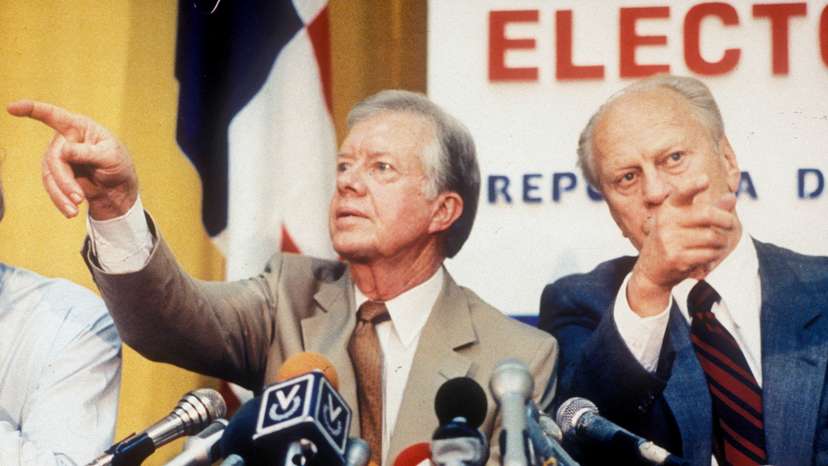 FILE PHOTO: Former U.S. Presidents Carter and Ford point in different directions at a press conference in Panama City