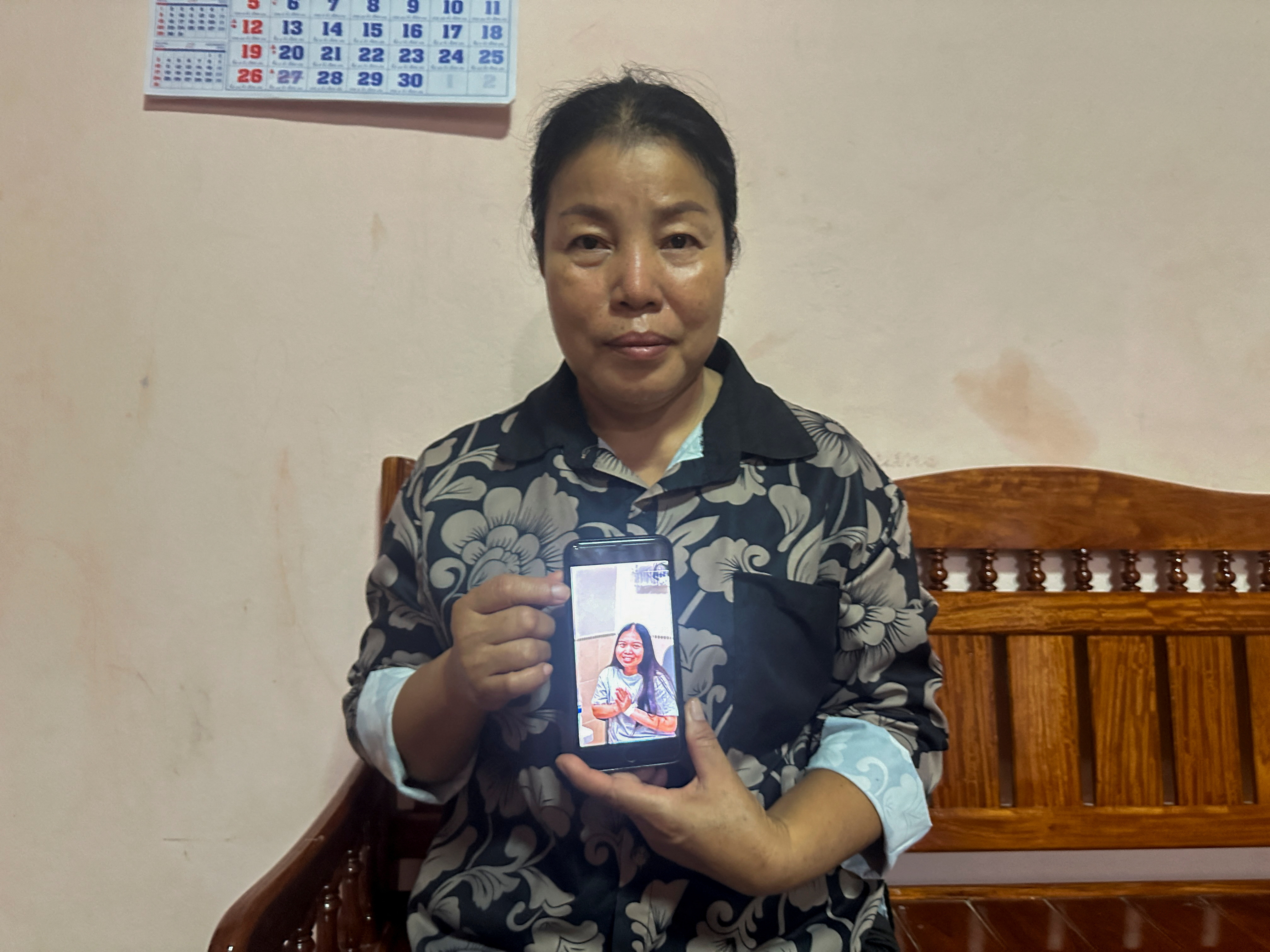 Bunyarin Srijan, the mother of a Thai hostage released as part of a hostages-prisoners swap deal between Hamas and Israel, holds her phone showing an image of her daughter, Natthawaree Mulkan, during an interview at her home in Khon Kaen