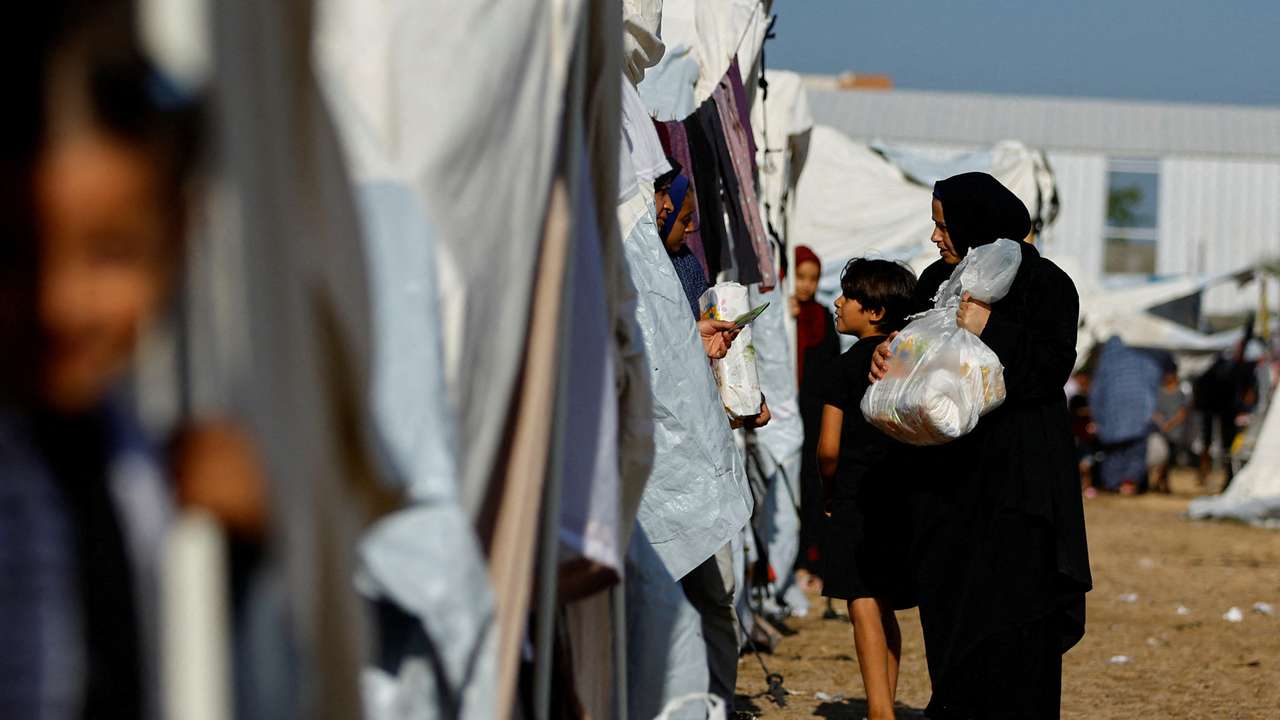 FILE PHOTO: Palestinians, who fled their houses amid Israeli strikes, take shelter at a tent camp at a United Nations-run centre, in Khan Younis