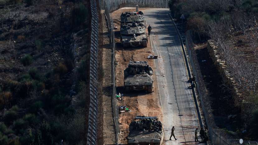 Israeli soldiers gather near the ceasefire line between Syria and the Israeli-occupied Golan Heights