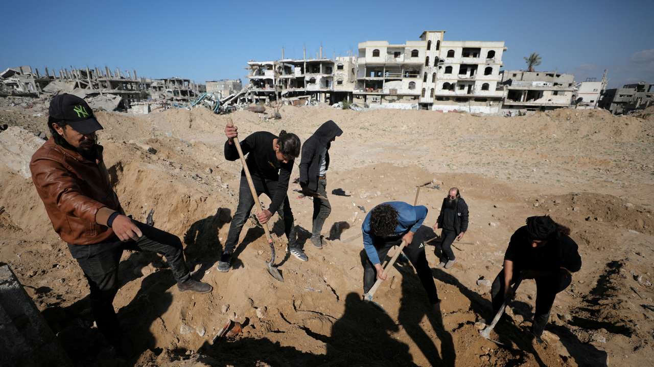 Palestinians search for bodies and graves of loved ones following a ceasefire, in Gaza City
