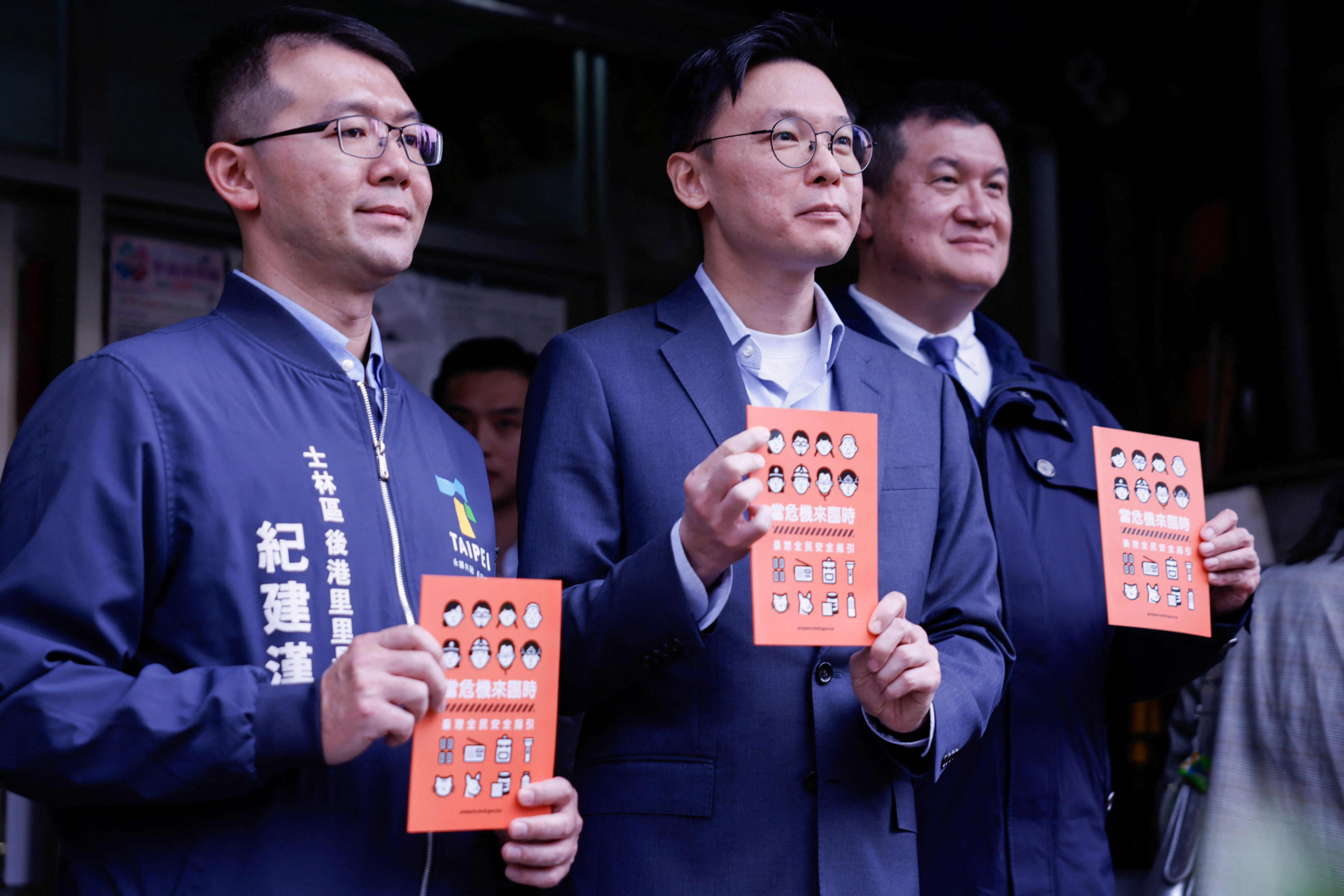 Deputy Secretary-General of Taiwan's National Security Council Lin Fei-fan holds a civil defence handbook in Taipei