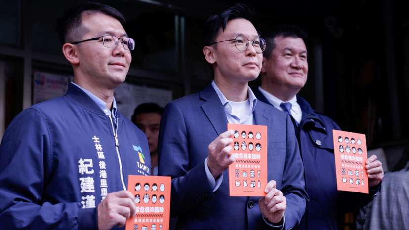 Deputy Secretary-General of Taiwan's National Security Council Lin Fei-fan holds a civil defence handbook in Taipei