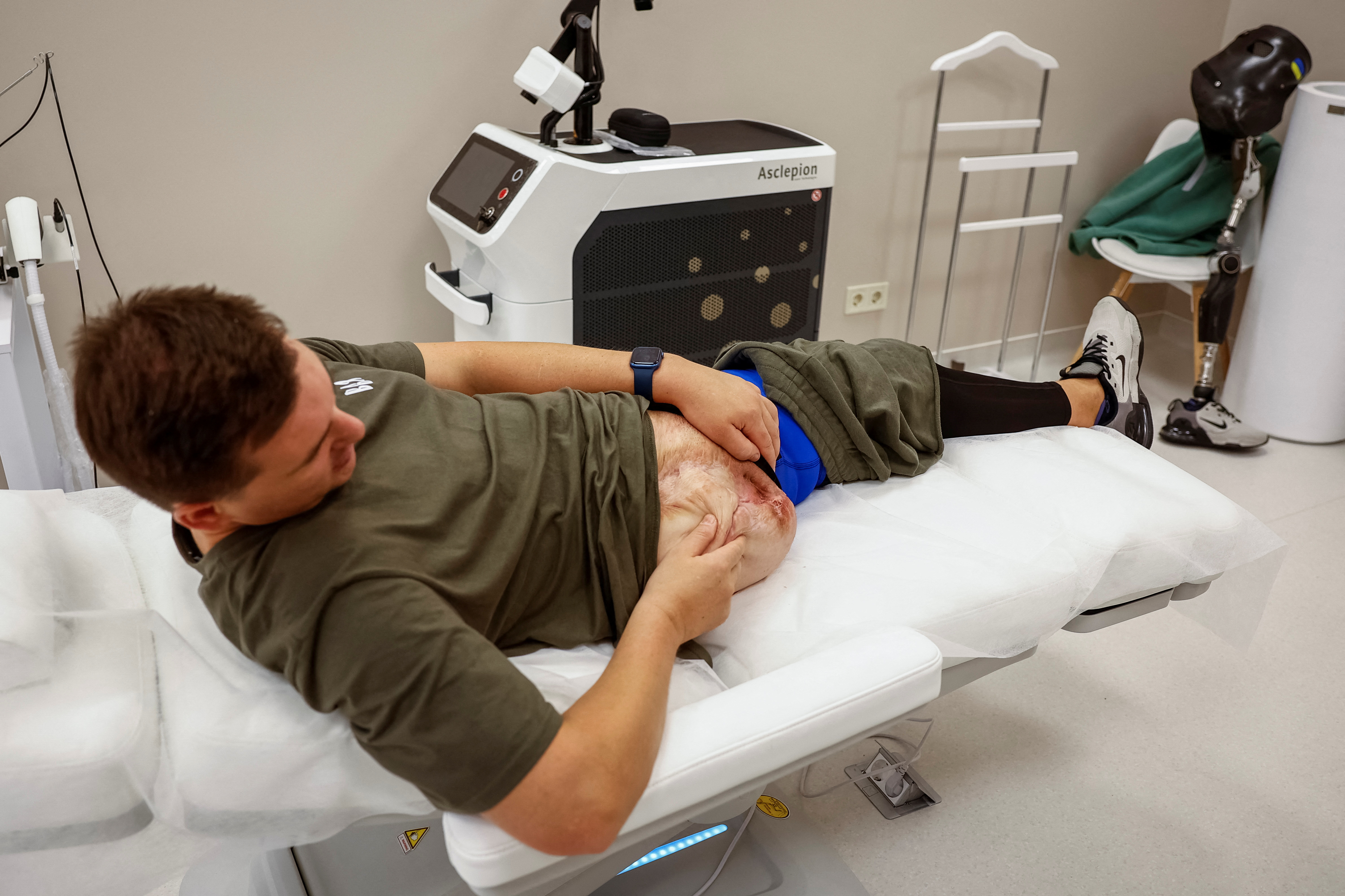 Former Ukrainian serviceman, who was wounded at a front line, comes to a clinic to treat scars, in Kyiv