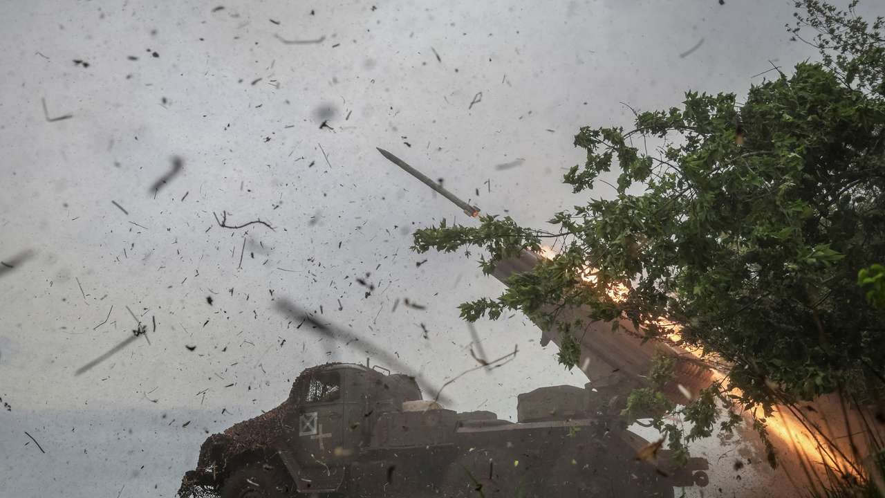 FILE PHOTO: Ukrainian servicemen fire a BM-21 Grad multiple launch rocket system towards Russian troops in Donetsk region