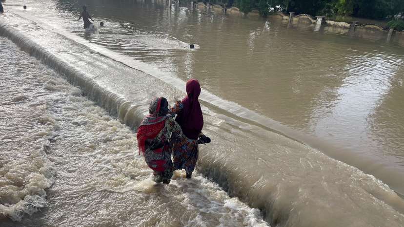 FILE PHOTO: Residents leave the flooded areas with their belongings in Maiduguri