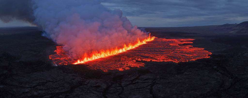 Lava emerges through a fissure following a volcano eruption near Grindavik