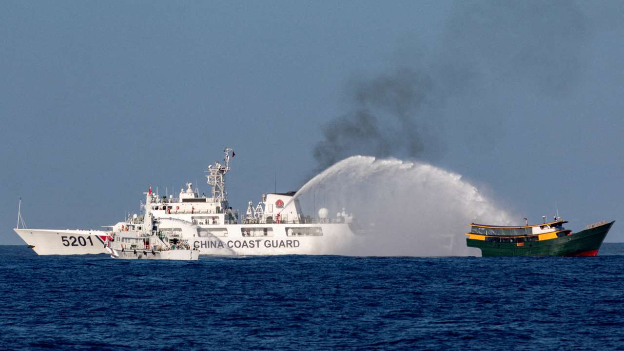 FILE PHOTO: Chinese Coast Guard vessels fire water cannons towards a Philippine resupply vessel Unaizah May 4 on its way to a resupply mission at Second Thomas Shoal in the South China Sea