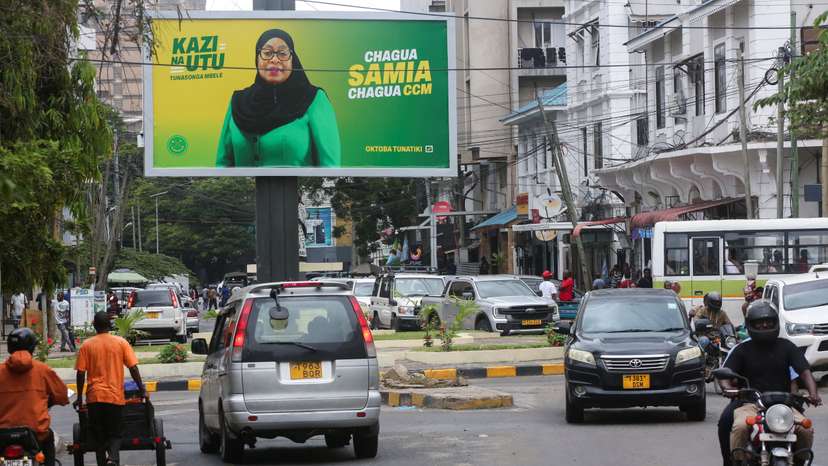 Motorists drive past an electoral campaign billboard of Tanzania's President Samia Suluhu Hassan of the ruling CCM ahead of the general elections in Ilala district of Dar es Salaam