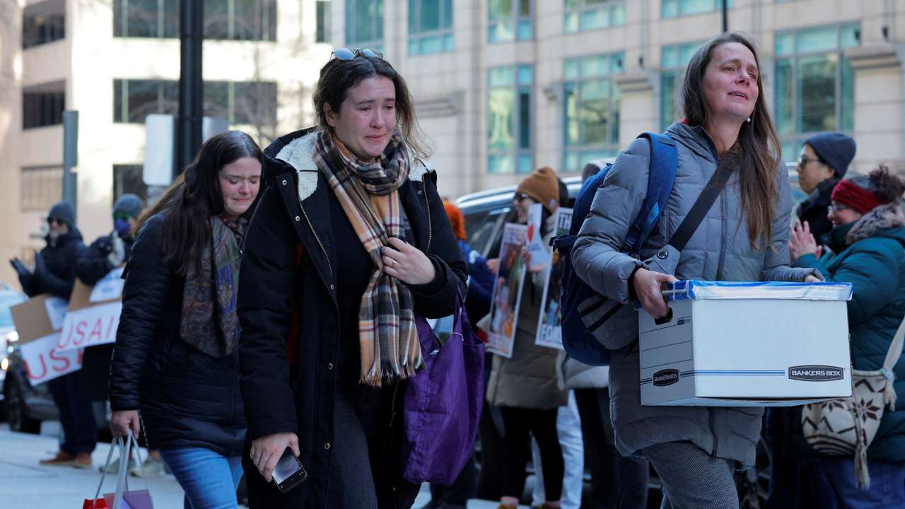 Recently fired USAID staff leave the office in Washington