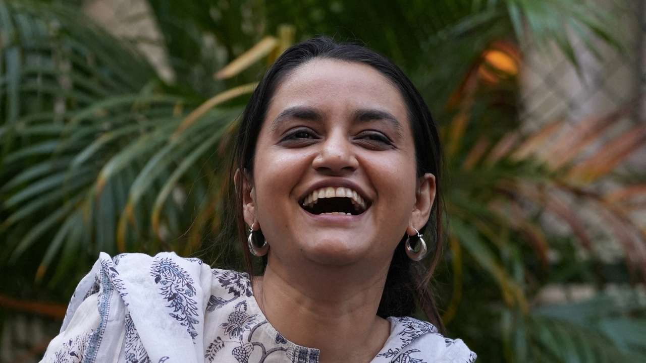 Director Payal Kapadia reacts as she poses after her interview with Reuters