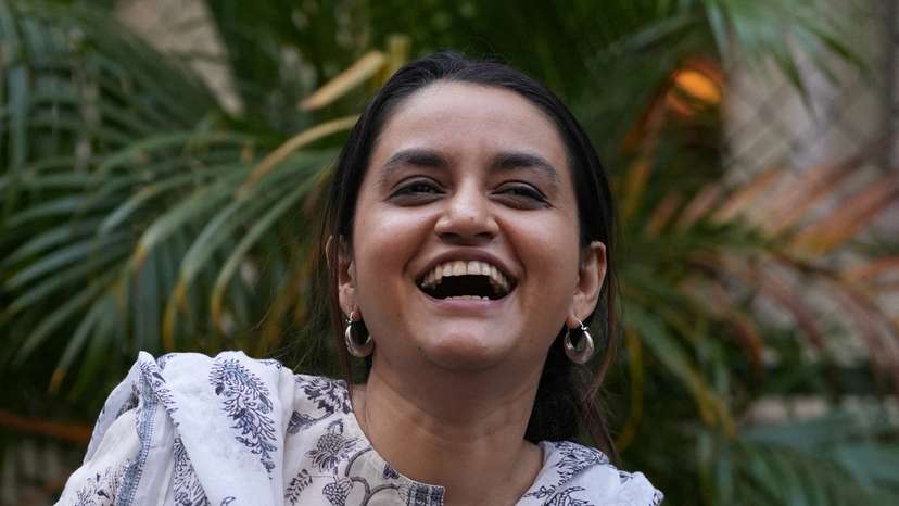 Director Payal Kapadia reacts as she poses after her interview with Reuters