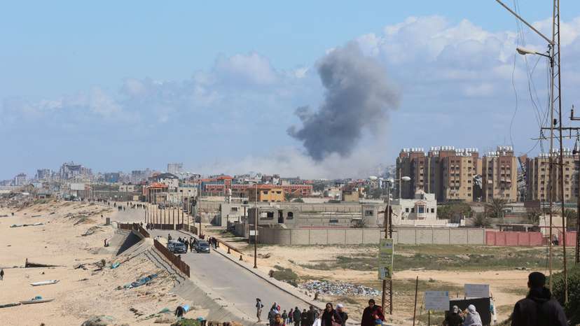 Smoke rises following an Israeli strike as Palestinians fleeing north Gaza due to Israel’s military offensive move southward, at the central Gaza Strip