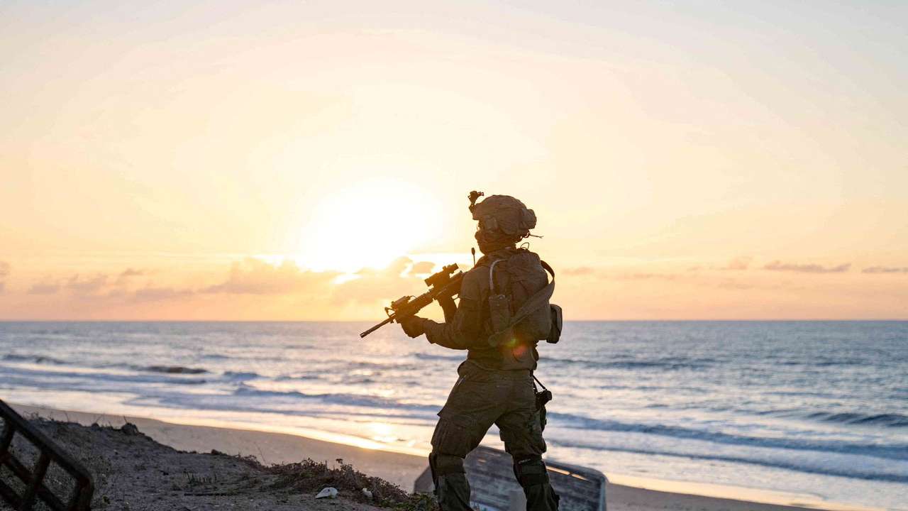 Israeli soldiers take position during the ongoing ground operation of the Israeli army against Palestinian Islamist group Hamas